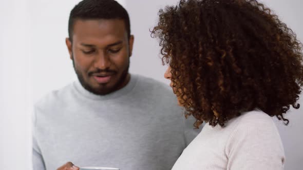 African American Couple Drinking Coffee at Home