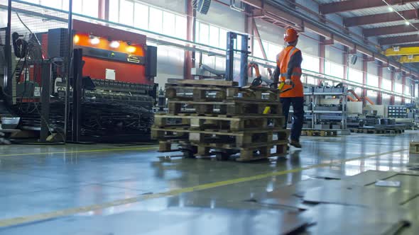 Female Factory Worker Using Hand Truck