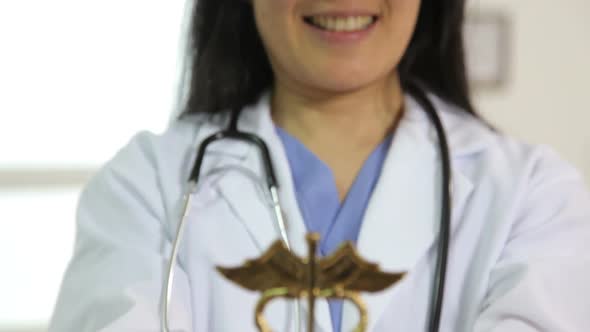 Doctor holding caduceus in hands