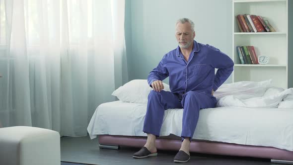 Senior Man Feeling Sharp Pain in Back After Waking Up, Poor Sleeping Conditions