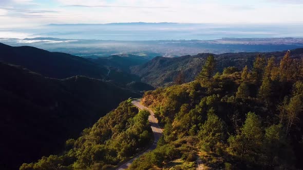 Cyclist on curvy Mountain Road above Santa Barbara at Dawn, Drone Chase