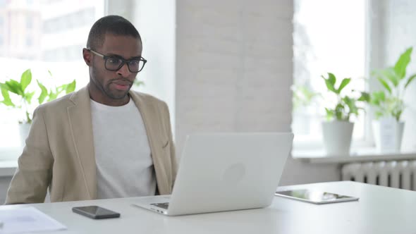 African Man Closing Laptop Standing Up Going Away