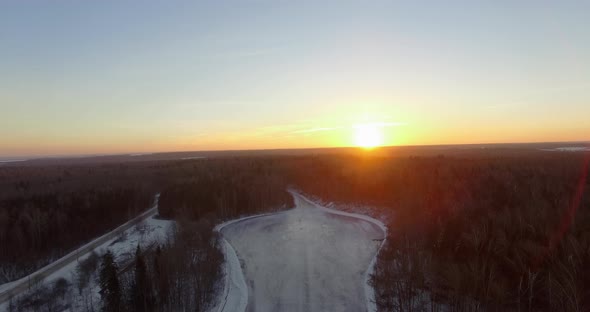 Aerial Landscape of Sunrise Over the Forest in Winter