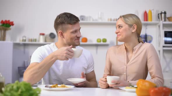 Attractive Couple Drinking Tea After Meal for Better Digestion, Water Balance