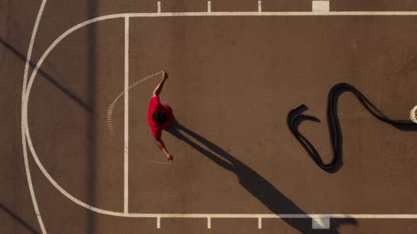 Aerial shot of a man working out with a jump-rope