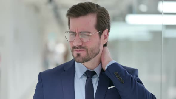 Stressed Young Businessman Having Neck Pain