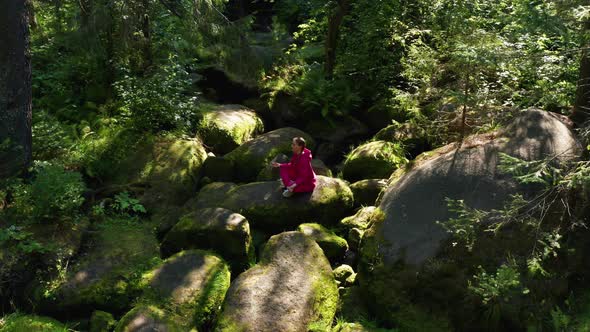 A Girl Practices Yoga in the Forest