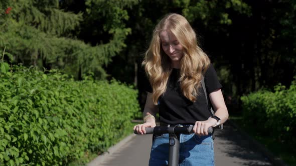 Smiling Girl Rides On Electric Scooter