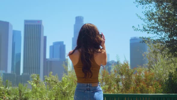 Back View Brunette Tourist Making Video Cityscape Standing in Green Park