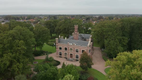 Aerial overview of a beautiful old mansion on a lush, green estate