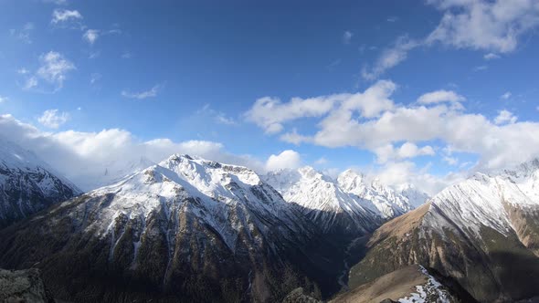 Timelapsewide Angle High Above the Gorge Quickly Float Clouds Covering the Snowcapped Peaks of High