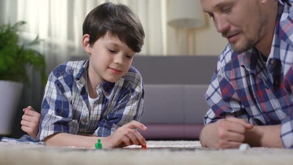 Father and Son Playing Exciting Board Game, Parent Developing Boys Skills
