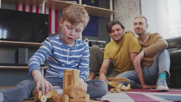 Boy with Two Fathers Playing with Toys