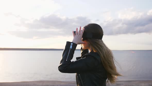 Portrait of Young Woman in Vr Glasses Outdoors with Beatiful Sea Sunset Background Slow Motion