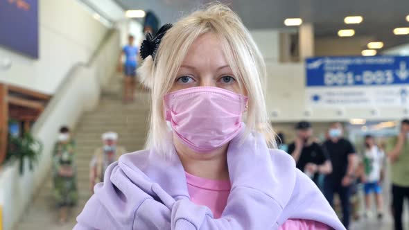 Woman Wearing Medical Protective Mask in Airport Terminal