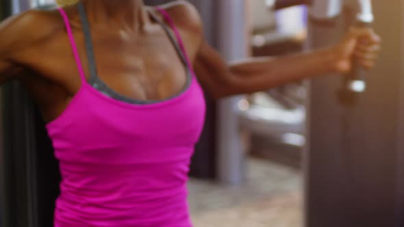 Fit woman exercising on pec fly machine