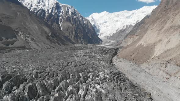 Aerial Over Hopar Glacier In Nagar Valley With Snow Capped Mountains. Pedestal Up