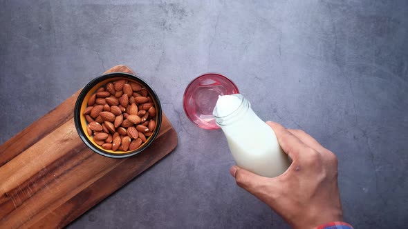 Top View of Pouring Milk Into the Glass on Table