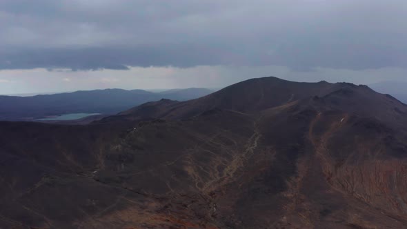 Aerial View of the Mountain Against the Background of Clouds and a Mountain Range