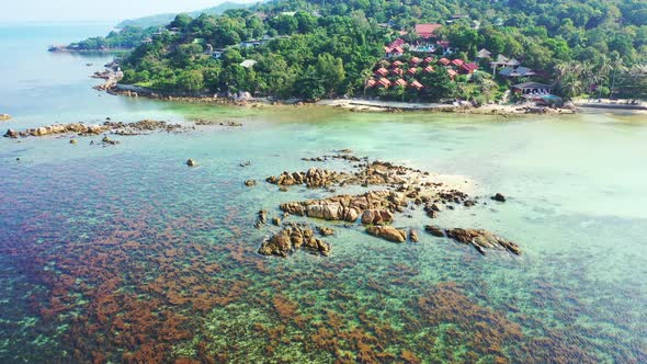 Thailand, aerial. Clear and calm emerald sea water with seaweed and rocks on the coast of the exotic