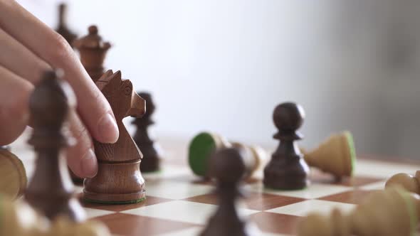 Girl Makes Knight's Move. Slow Movement Of Chess Piece On Wooden Chessboard. Business Woman