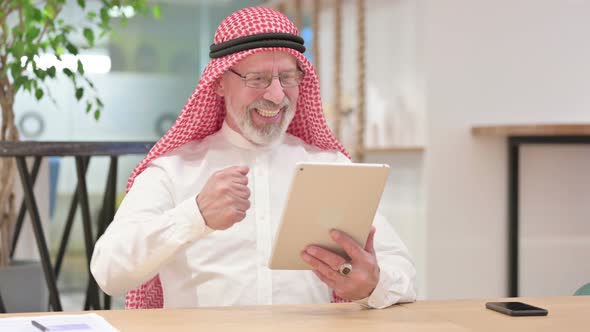 Excited Senior Old Arab Businessman Celebrating Success on Tablet