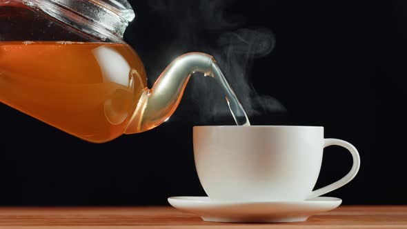 Pouring Citrus Black Tea on Black Background