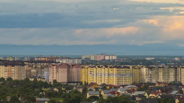 Time Lapse Footage of Fast Moving Evening Clouds on Yellow Sky Over Rural City Area with Distant