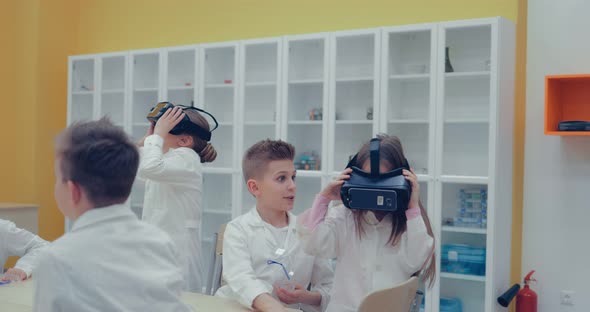 Little Children Teens in the Classroom Watching in Virtual Reality Glasses