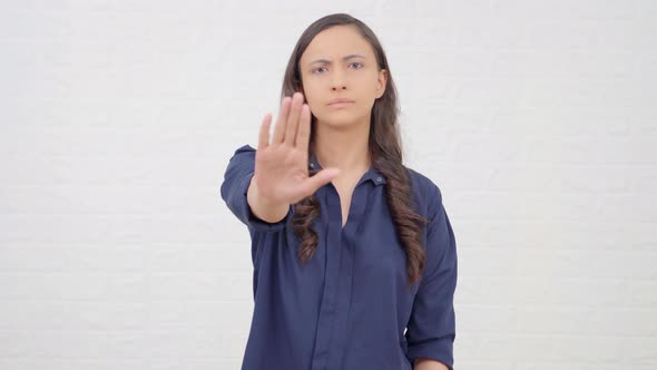 Indian girl showing STOP sign