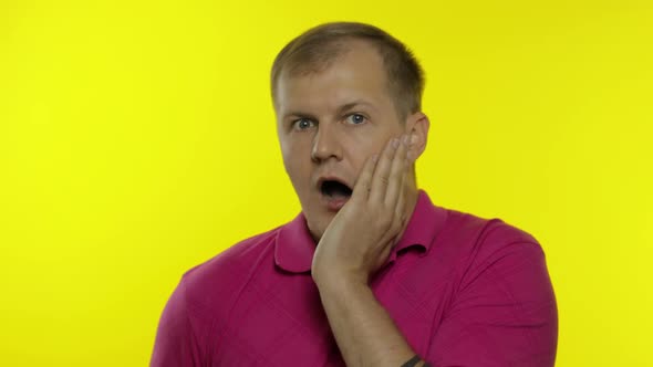 Portrait of Young Caucasian Man Posing in Pink T-shirt. Worried Handsome Guy Shocked, Afraid, Scared