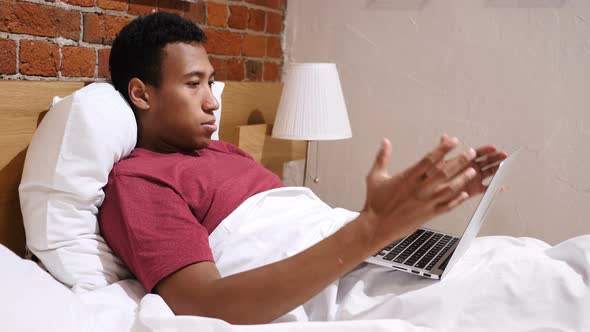 Angry Frustrated African Man Working Online at Night in Bed