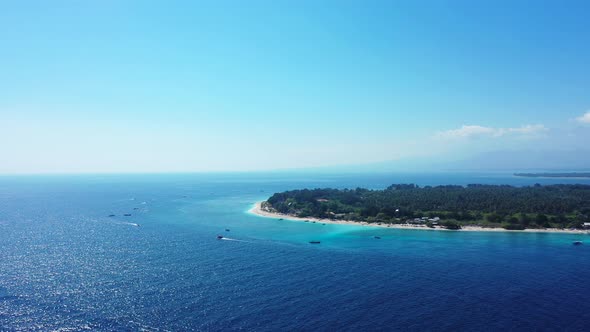 Natural birds eye travel shot of a white sand paradise beach and aqua blue water background in colou