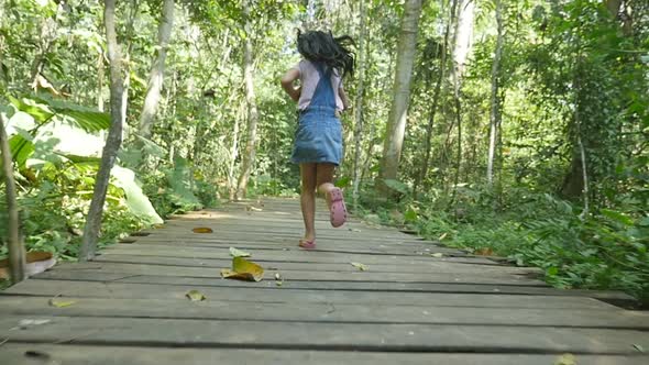 Little Girl Running On Wooden Path alt