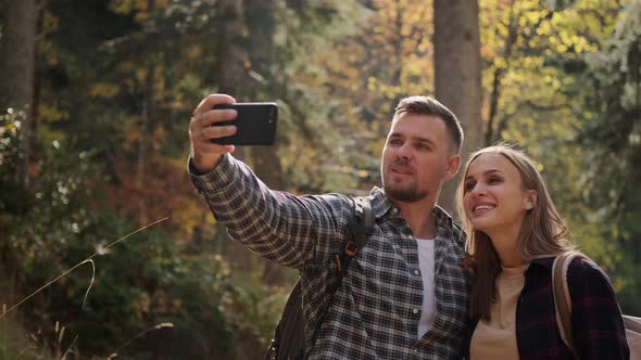 Travellers Bloggers are Filming Themselves During Hike in Forest Taking Selfie By Smartphone