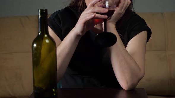 Unrecognizable Tipsy Woman with Stressed Face Expression Drinks Wine