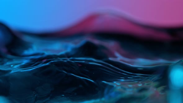 Super Slow Motion Abstract Shot of Swirling Neon Water at 1000Fps