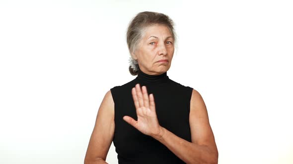 Caucasian Serious Woman with White Tied Hair Waving Hand in Rejection Saying No Over White