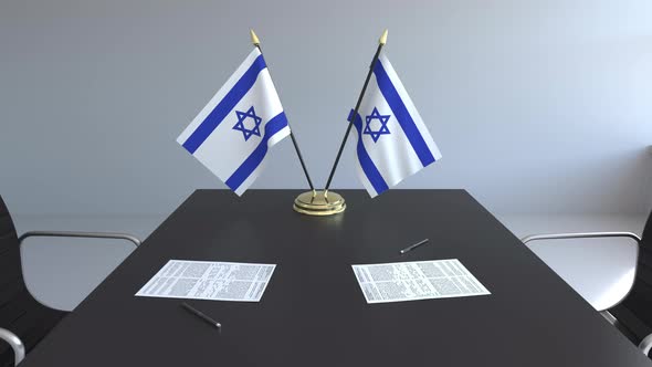 Flags of Israel and Papers on the Table alt