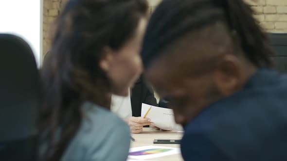 Caucasian Woman and African American Man Whispering at Business Meeting. Serious Nervous CEO