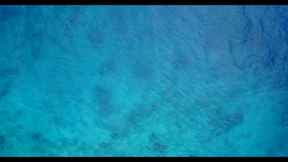 Aerial seascape of exotic island beach adventure by blue lagoon with white sandy background of a day