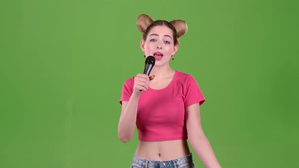 Teenager Sings Into the Microphone. Green Screen. Slow Motion