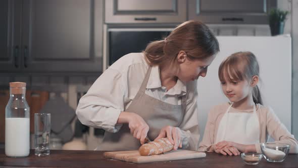 Mom And Daughter Tasting Homemade Bread