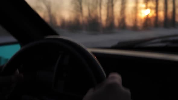 Driving - Man's Hands Holding the Steering Wheel