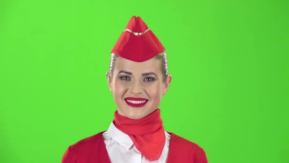 Stewardess Smiles Looks Into the Distance. Green Screen. Slow Motion. Close Up