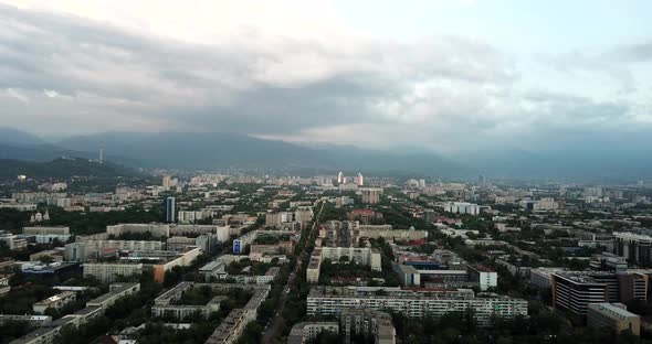 Top View of Almaty City. Green Streets, Big Clouds