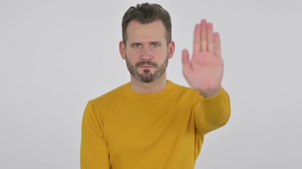 Portrait of Middle Aged Man Showing Stop Sign By Hand