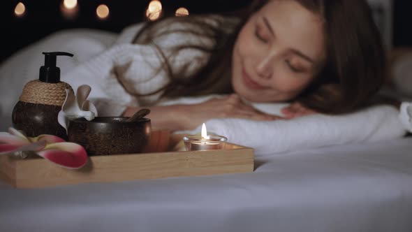 Beautiful Asian woman relaxing in the spa room