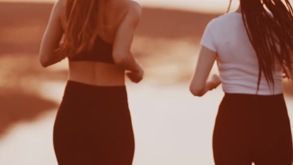 Two Young Women Jogging on Sunset Evening