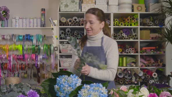 In the Studio of Floral Design Woman Florist at Work